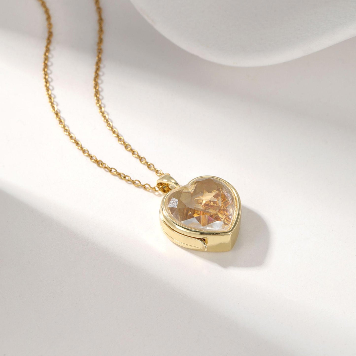 Personalized ismijewels heart locket necklace with attached charms, showcasing a custom engraved heart pendant.