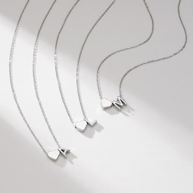 Personalized heart necklace with initials from ismijewels, featuring a silver chain and engraved lover's heart pendant.