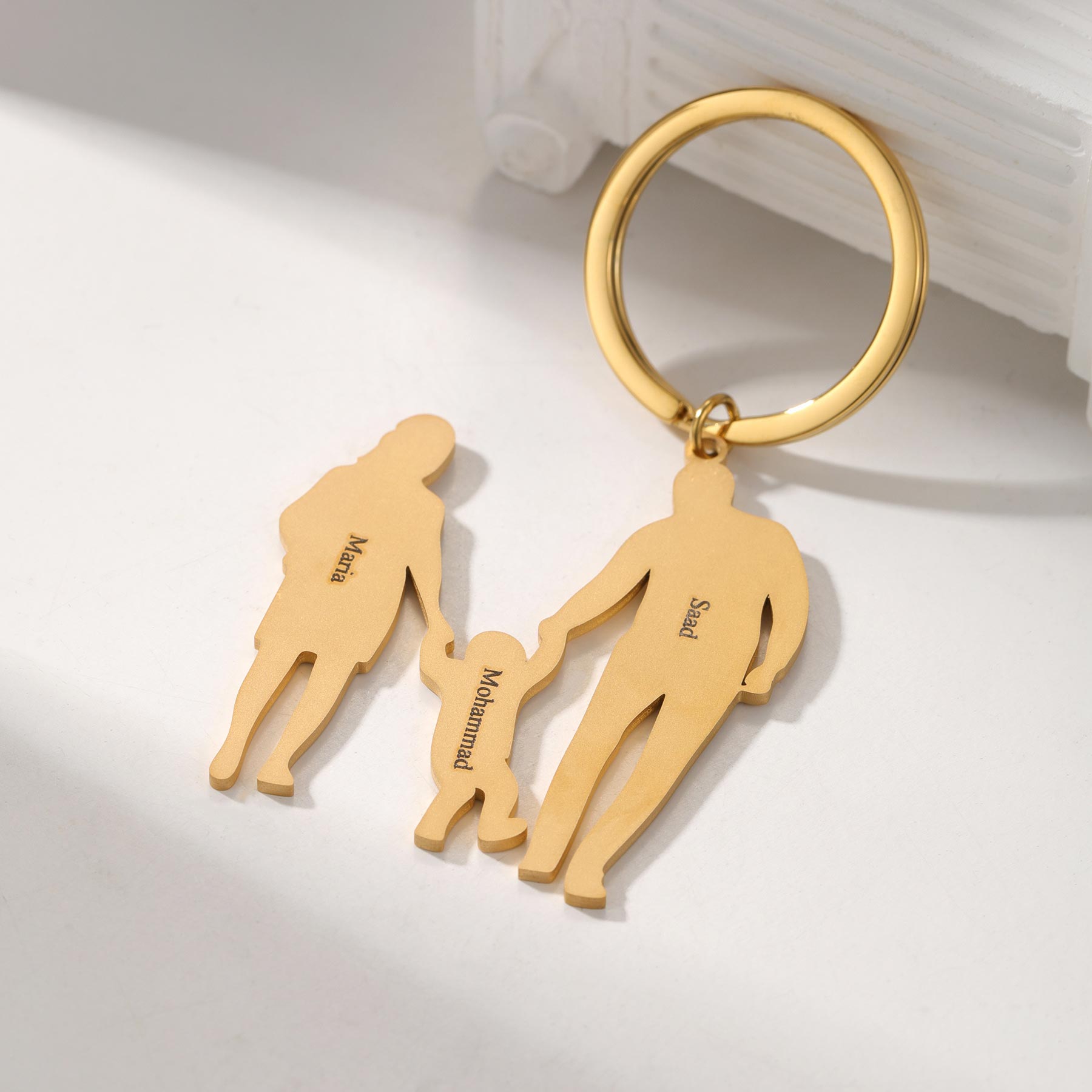 Custom 3-figure family keychain with personalized figures on a silver keyring, showcasing detailed, handcrafted family design.