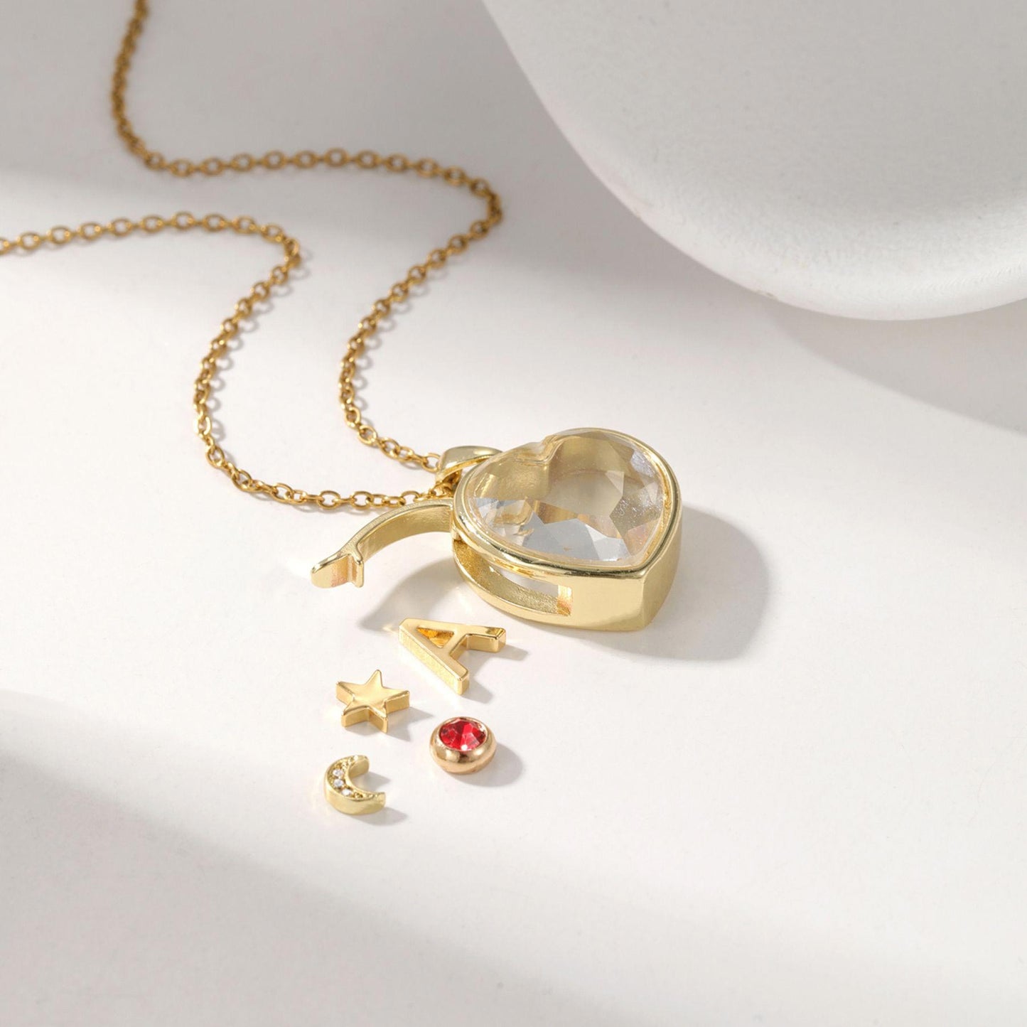 Personalized ismijewels heart locket necklace with charms, featuring intricate metalwork and a delicate chain.