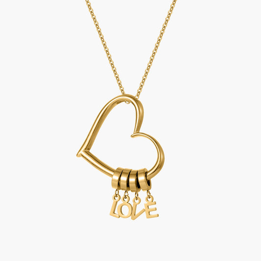 Gold personalized necklace with a heart pendant and dangling charms, featuring custom engravings for a unique jewelry piece.