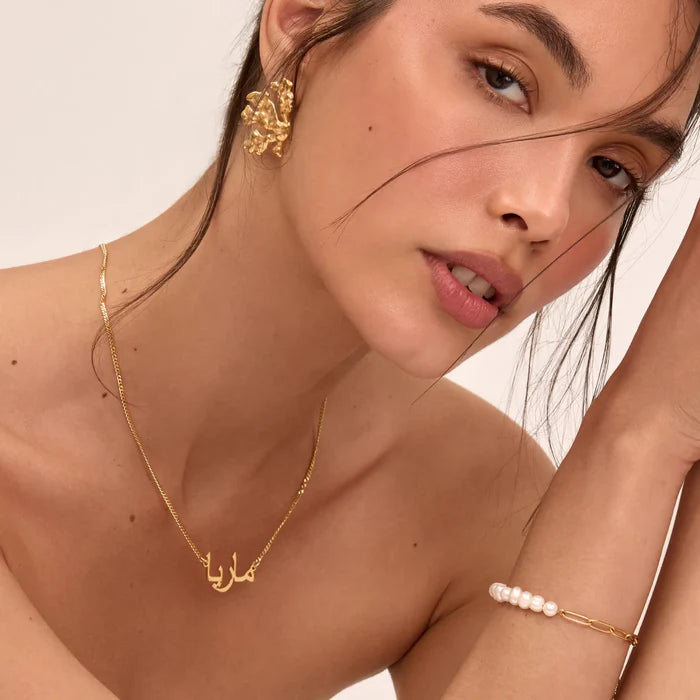 Personalized Arabic name necklace by ismijewels featuring a delicate chain and custom name pendant in elegant script.